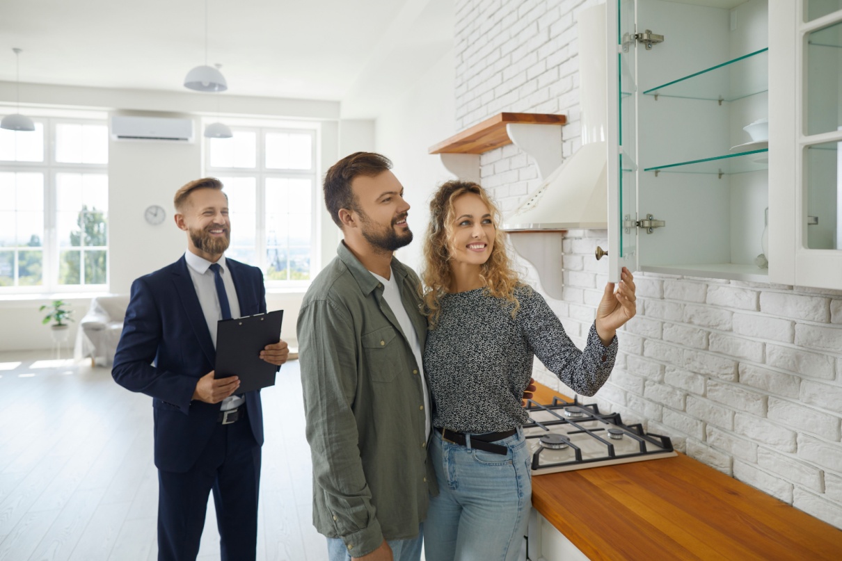 A couple viewing a property with an estate agent.